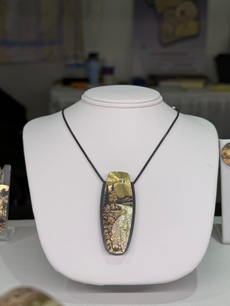 Pendant by Wolfgang Vaatz with gold, sterling silver, and a diamond. 