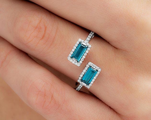 14K White Gold Emerald Cut Blue Topaz and Diamond Halo Bypass Ring