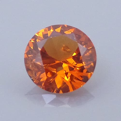 Finished version of Round Brilliant Cut Spessartite Garnet