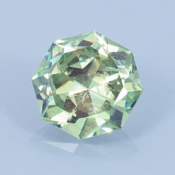 Finished version of Fancy Brilliant Octagon Cut Demantoid Garnet