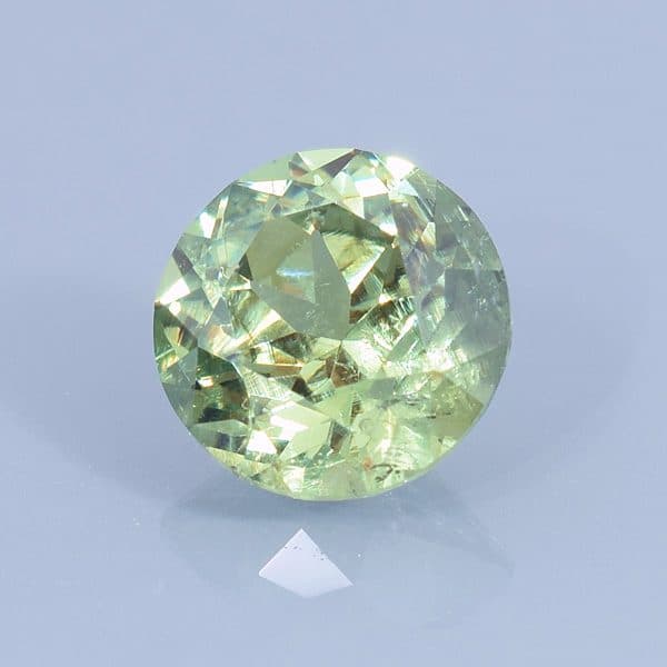 Finished version of Custom Round Brilliant Cut Demantoid Garnet