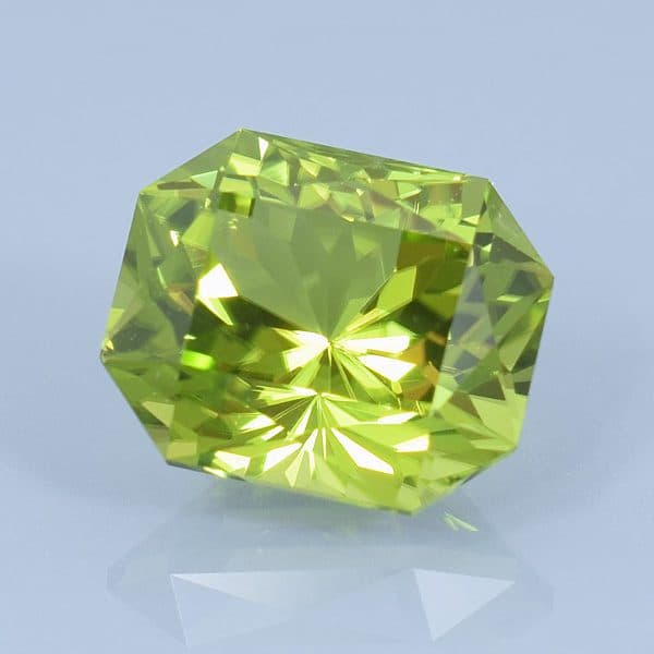 Finished version of Custom Brilliant Emerald Cut Peridot