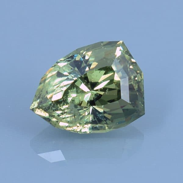 Finished version of Custom Shield Cut Demantoid Garnet