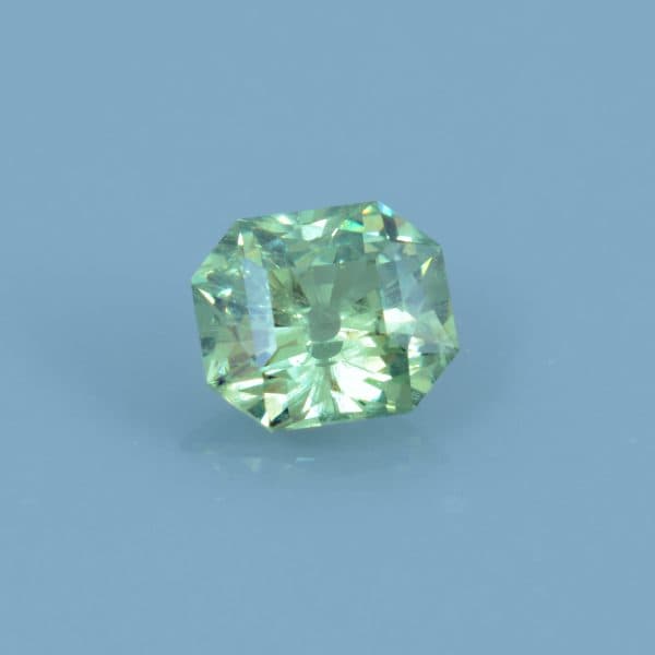 Finished version of Custom Emerald Cut Demantoid Garnet