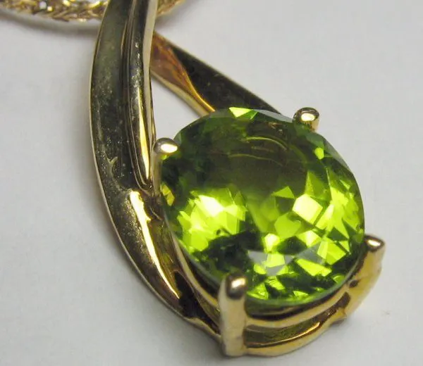 synthetic peridot in gold necklace