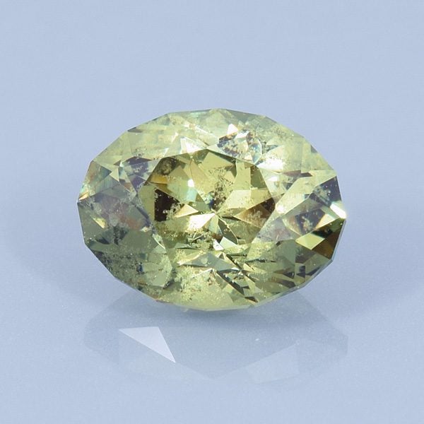 Finished version of Fancy Brilliant Oval Cut Demantoid Garnet