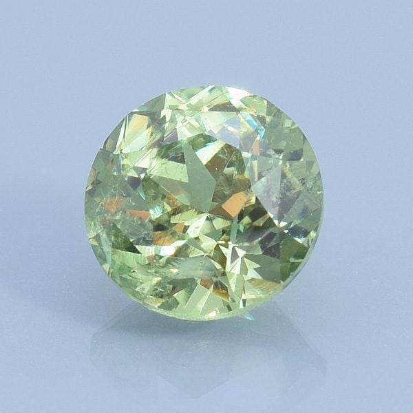 Finished version of Custom Round Brilliant Cut Demantoid Garnet