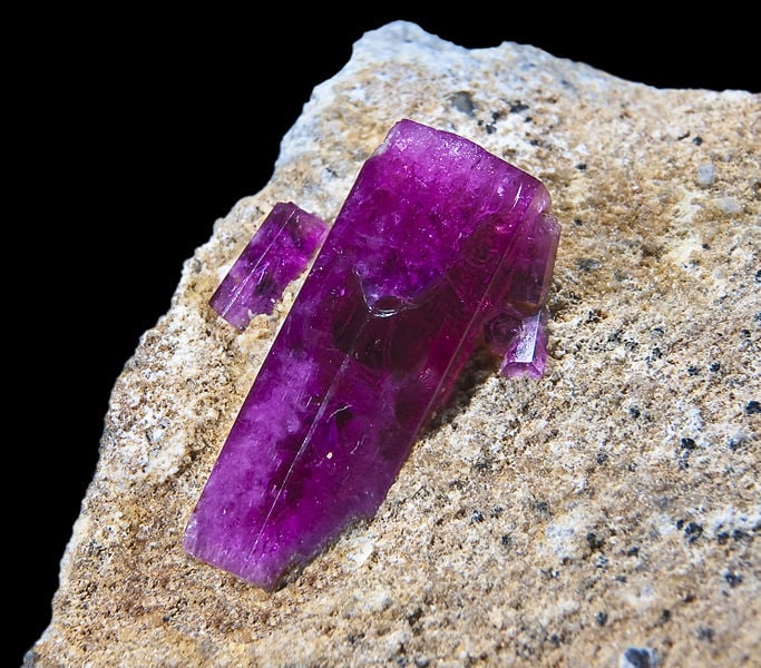 red beryl crystal on matrix