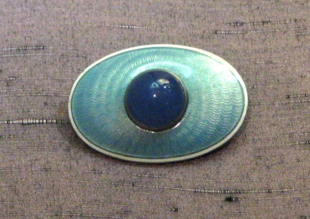 sapphirine, silver, and enamel brooch
