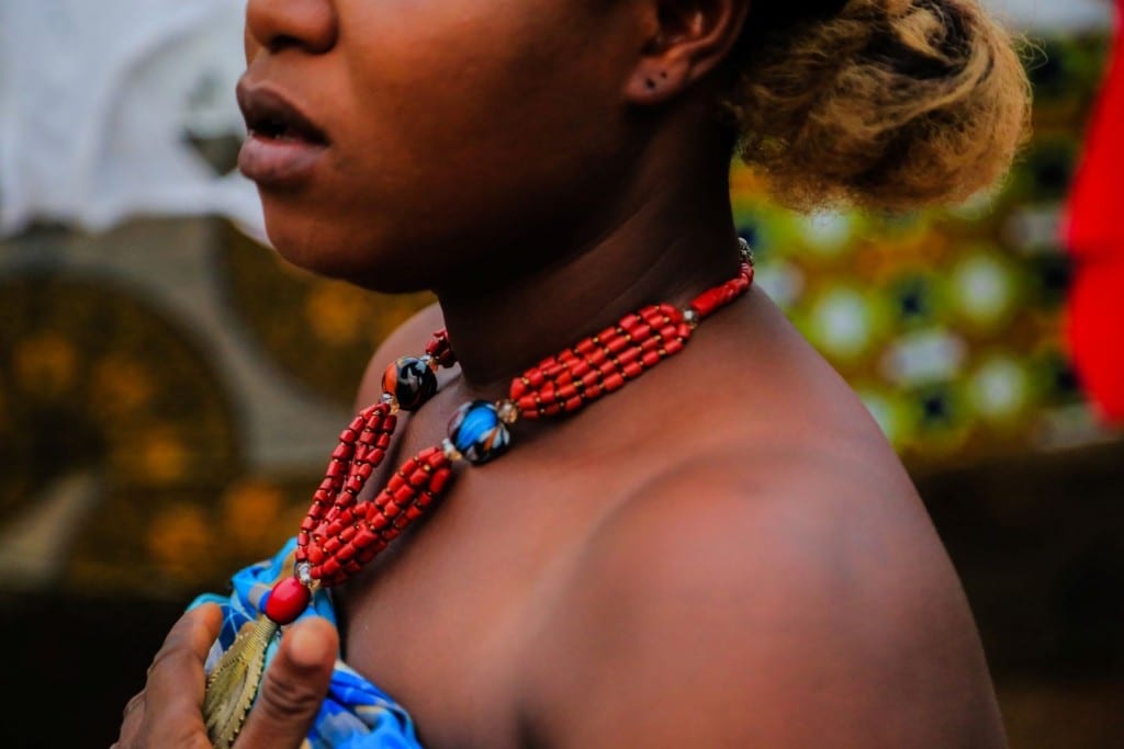 beadwork necklace with red corals, marble stones, and gold pendant