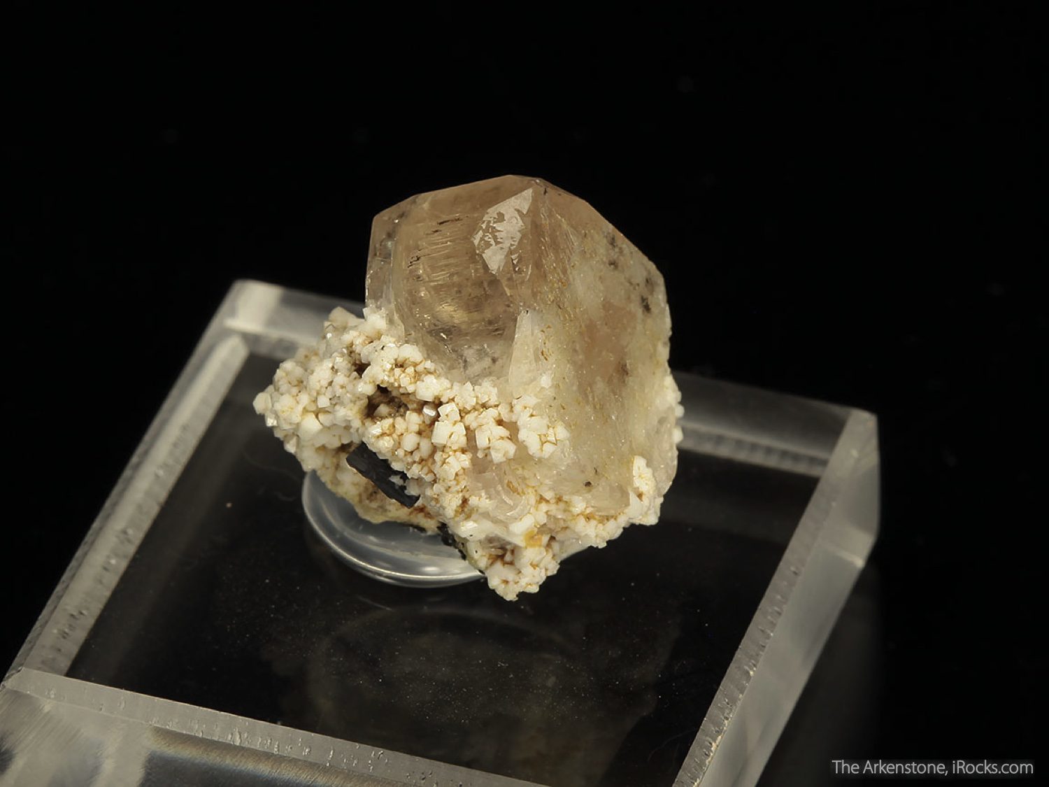 peach-tan zektzerite crystal on matrix