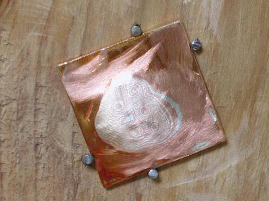 Marks being cut in the layers of metal