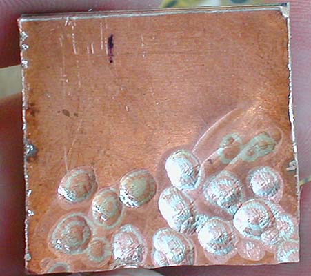 Marks being cut in the layers of metal