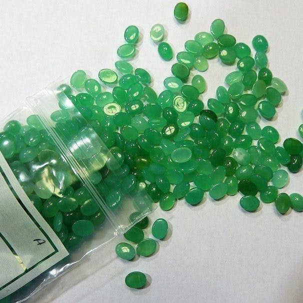 chrysoprase buying guide - bag of cabochons