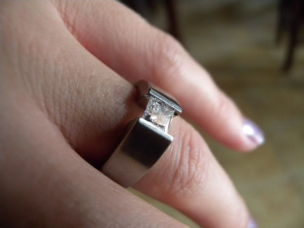 titanium engagement ring with tension-set diamond - protective gem settings