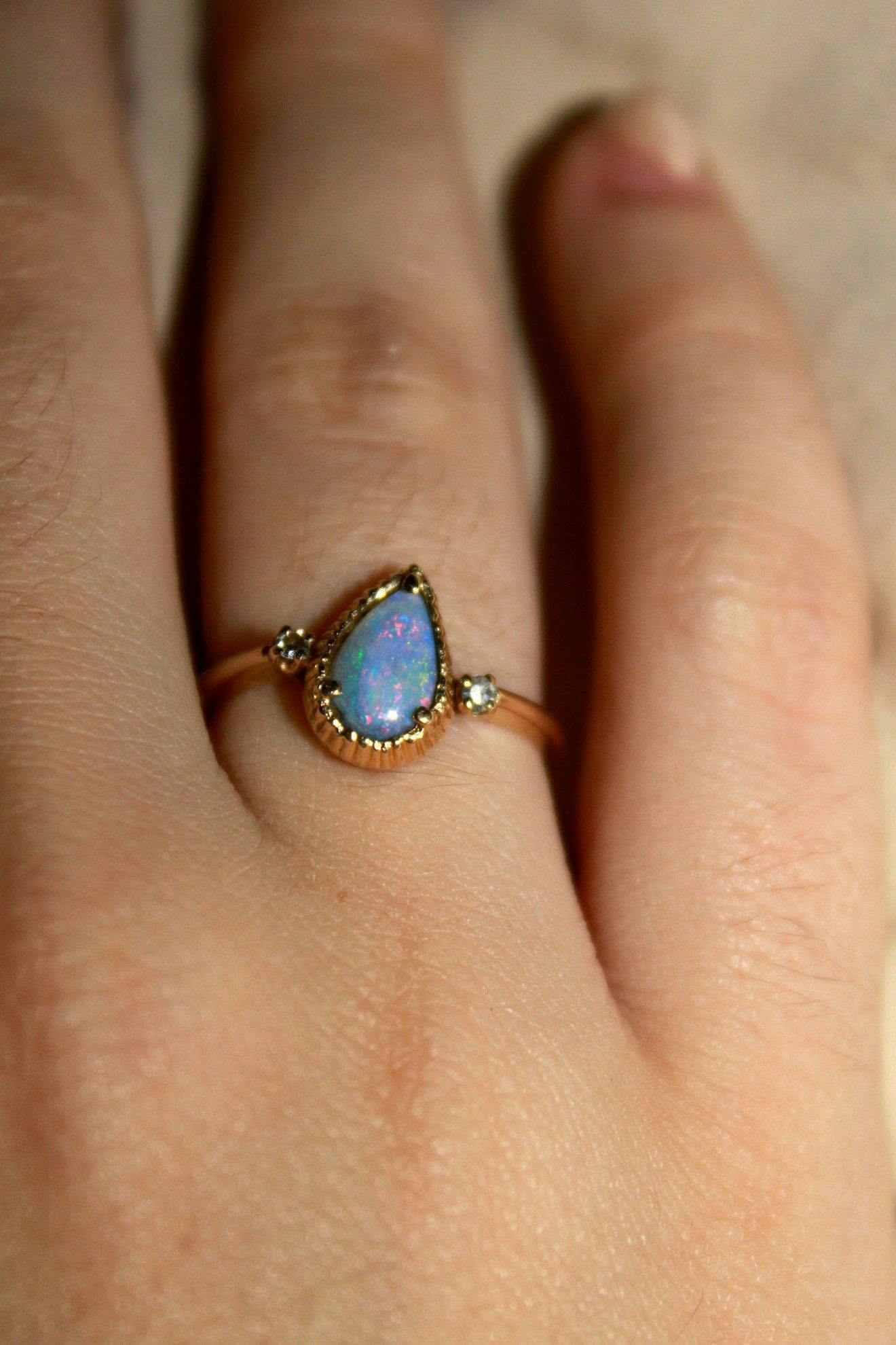 bezel-set opal ring with raised prongs - protective gem settings