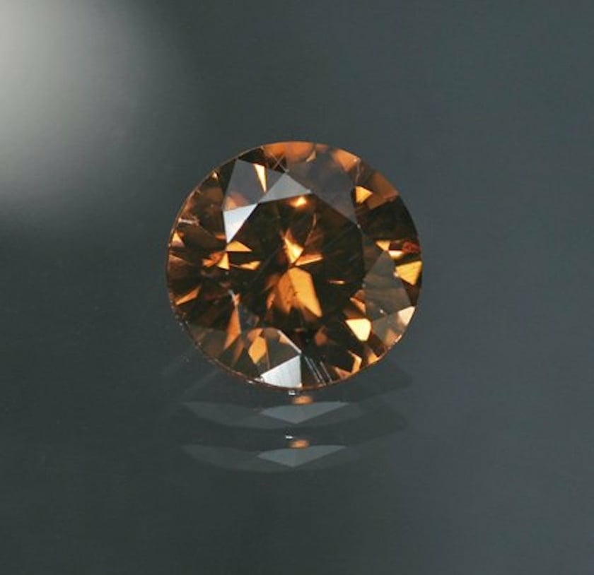 tenebrescent zircon, orangish brown