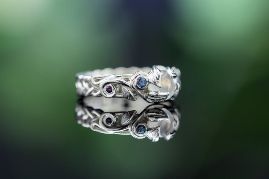engagement ring settings - decorative leaf prongs on a moonstone