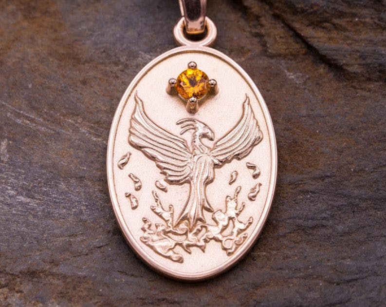 rose gold and spessartite garnet medallion - garnet symbolism and legends