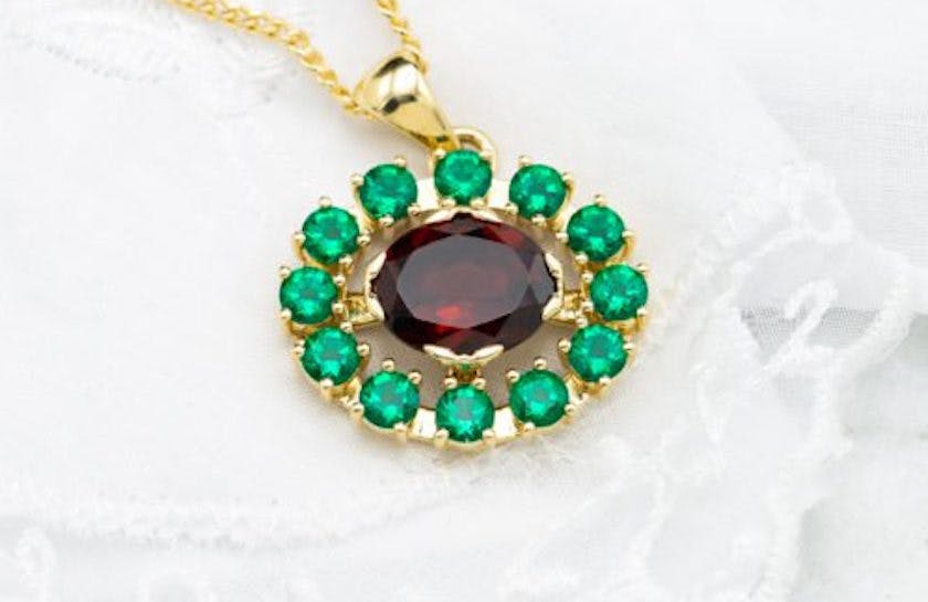 garnet and lab-created emerald pendant - garnet symbolism and legends