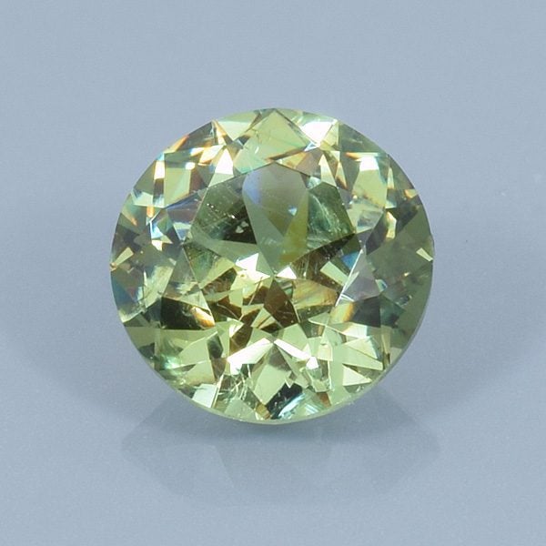 Finished version of FAncy Round Brilliant Cut Demantoid Garnet
