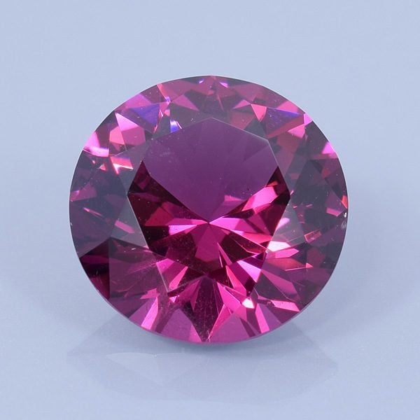 Finished version of Modified Round Brilliant Cut Rhodolite Garnet