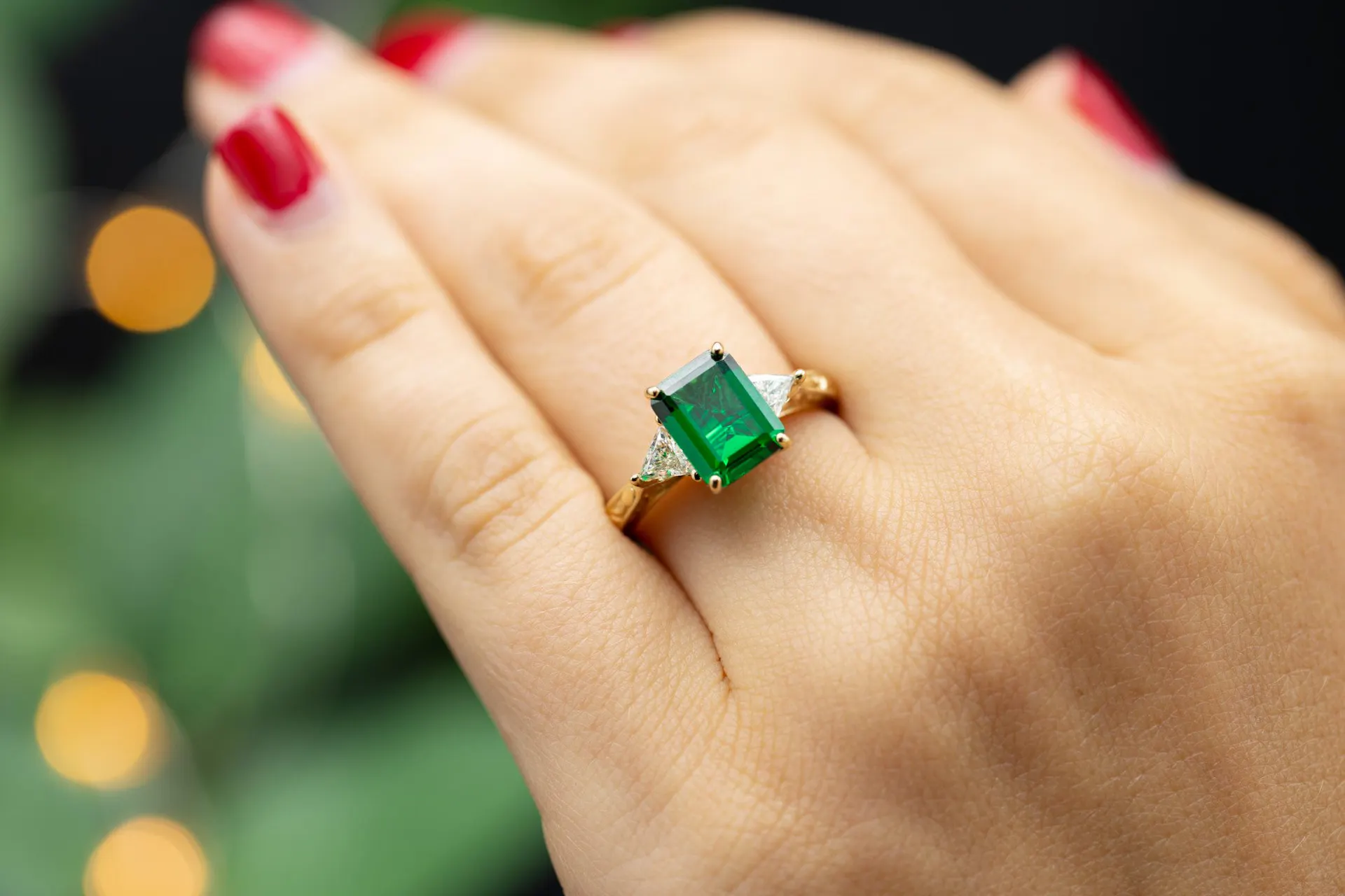three-stone emerald engagement ring