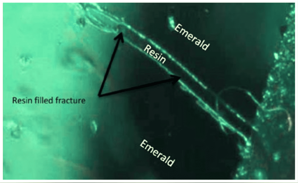 surface reaching fissure in resin-filled emerald