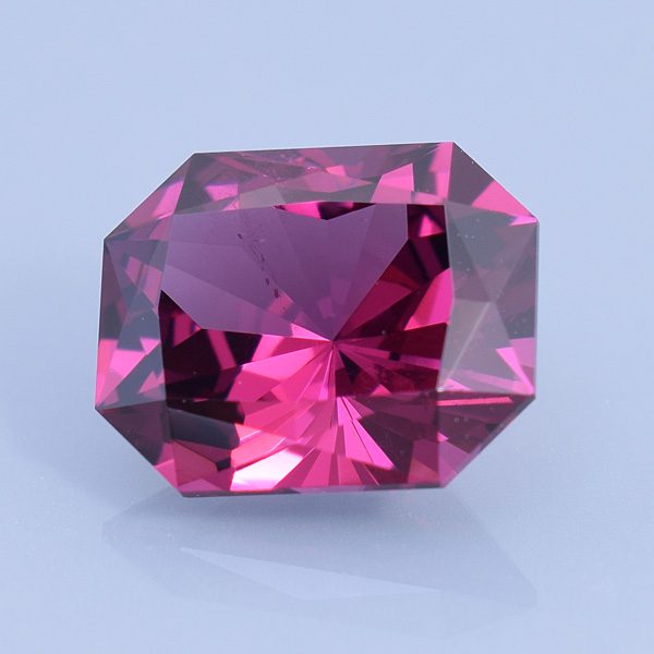 Finished version of Fancy Barion Emerald Cut Rhodolite Garnet