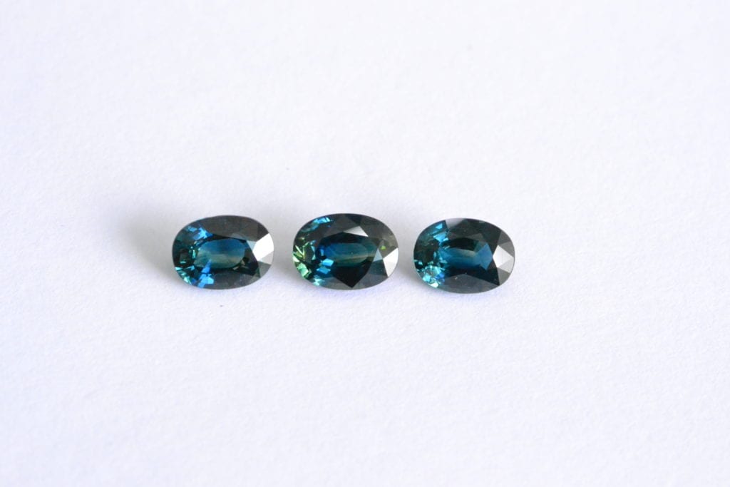 three teal sapphires