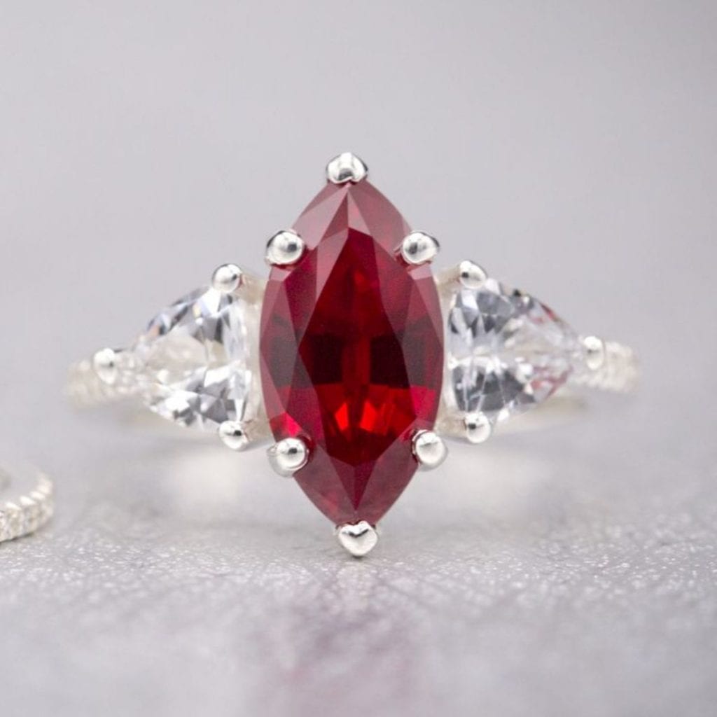 lab-created marquise ruby with trillion cut white sapphiren thin, elegant pave band Custom Made