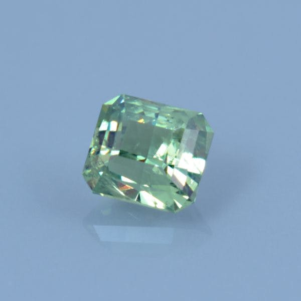 Finished version of Custom Emerald Cut Demantoid Garnet