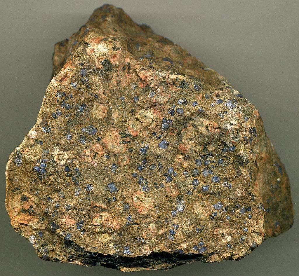 Llanite with phenocrysts of rare dark bluish quartz and orangish perthite - gem formation