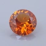 Finished version of Round Brilliant Cut Spessartite Garnet