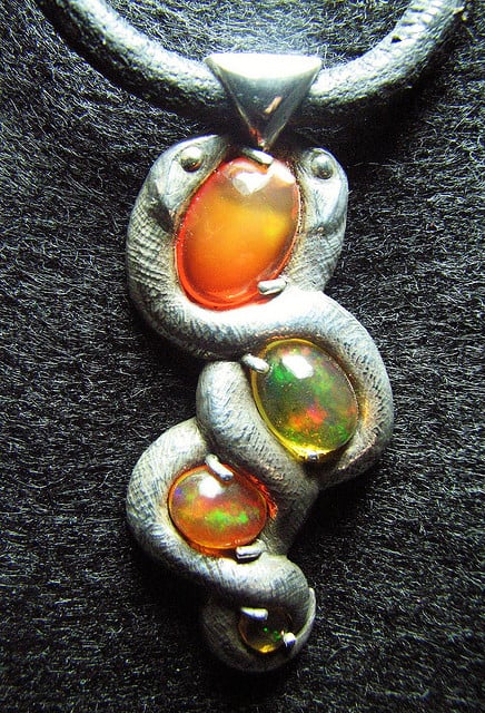 “Serpentine Fire Opal Pendant,” Mexican fire opals and sterling silver, by Jessa and Mark Anderson is licensed under CC By 2.0