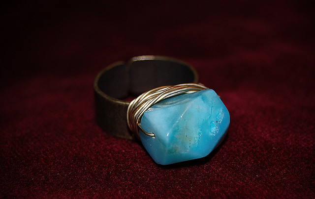 “Peruvian opal wire wrapped ring with brass band” by Zoe is licensed under CC By 2.0