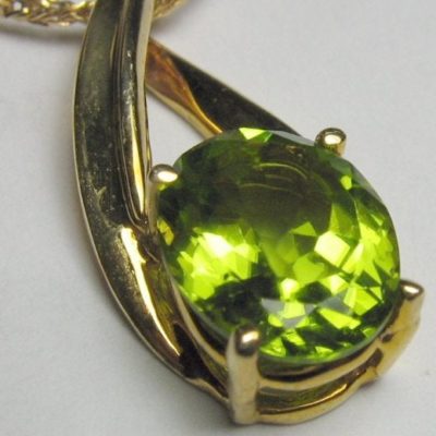 synthetic peridot in gold necklace