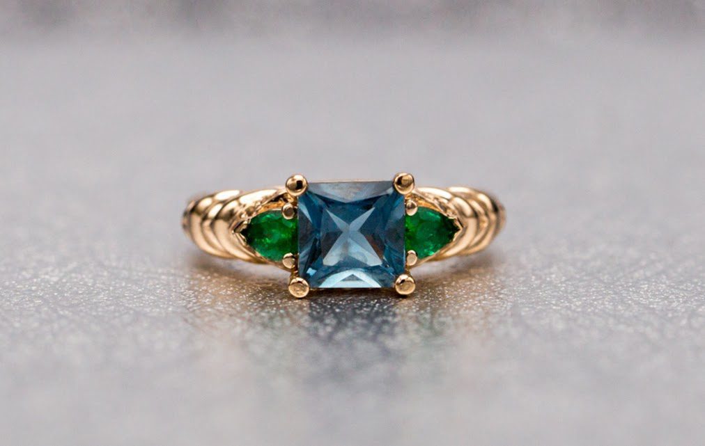 London Blue topaz engagement ring with emerald accents