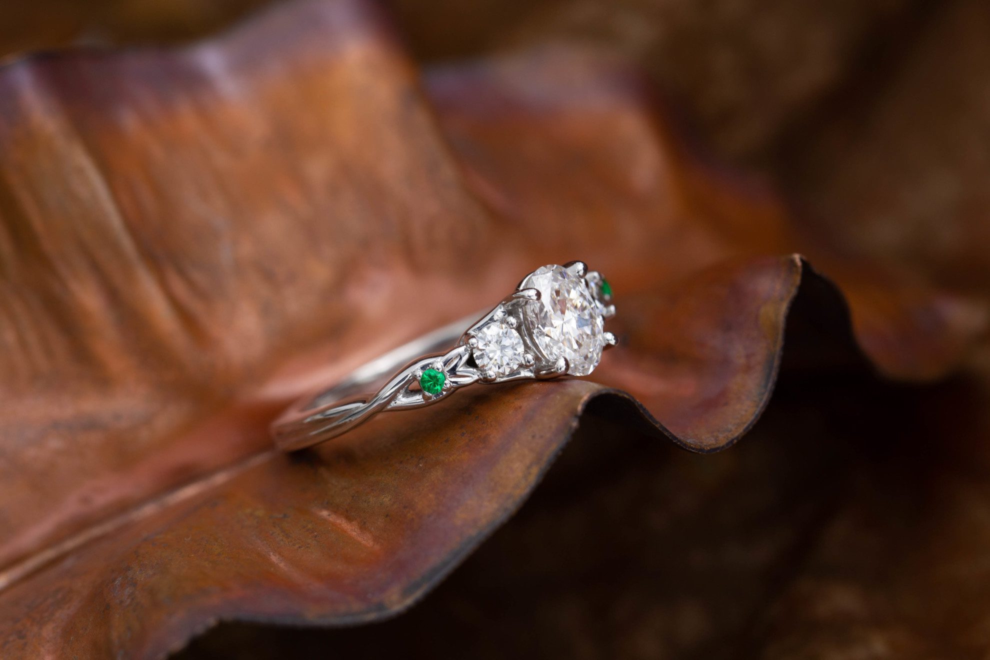 oval-cut diamond guide - engagement ring with emerald accents