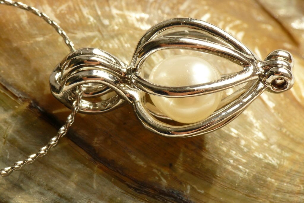 pearl cage setting - delicate engagement ring stones