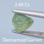 Rough version of FAncy Round Brilliant Cut Demantoid Garnet