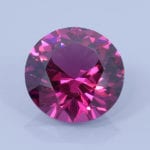 Finished version of Modified Round Brilliant Cut Rhodolite Garnet