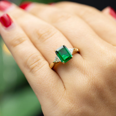 three-stone emerald engagement ring