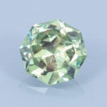 Finished version of Fancy Brilliant Octagon Cut Demantoid Garnet