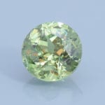 Finished version of Custom Round Brilliant Cut Demantoid Garnet